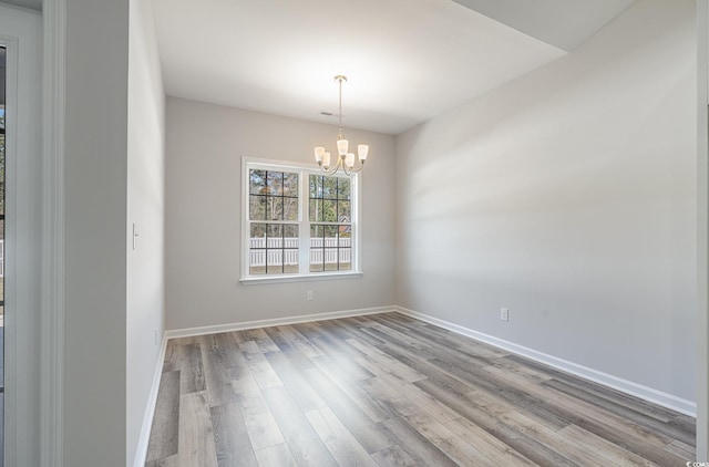 442 Lifestyle Ct, Surfside Beach, SC 29575 - spare room featuring wood finished floors and a chandelier