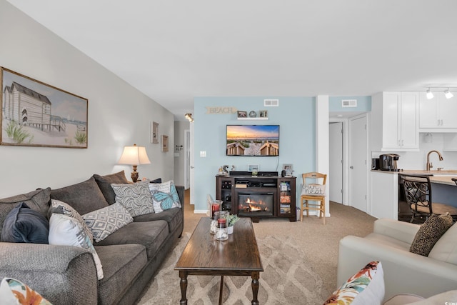 1500 Cenith Dr Unit E302, North Myrtle Beach, SC 29582 - living area with track lighting, light colored carpet, and a glass covered fireplace