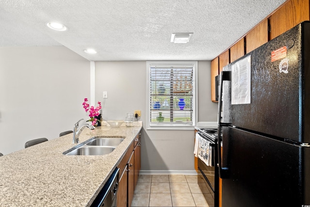351 Lake Arrowhead Rd Unit 24-193, Myrtle Beach, SC 29572 - kitchen with black appliances, brown cabinets, light tile patterned flooring, a peninsula, and a textured ceiling