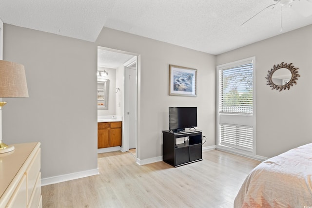 351 Lake Arrowhead Rd Unit 24-193, Myrtle Beach, SC 29572 - bedroom featuring light wood-type flooring, a textured ceiling, and connected bathroom