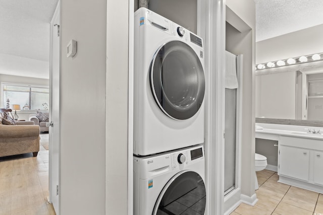 351 Lake Arrowhead Rd Unit 24-193, Myrtle Beach, SC 29572 - washroom with stacked washing machine and dryer and light tile patterned floors
