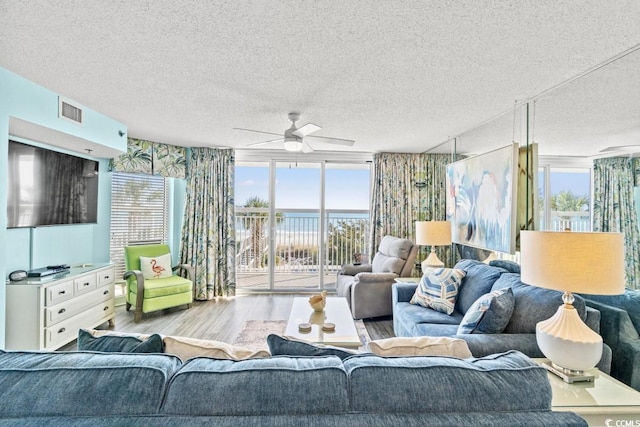 1625 S Ocean Blvd Unit 107, North Myrtle Beach, SC 29582 - living room with a textured ceiling, wood finished floors, ceiling fan, and healthy amount of natural light