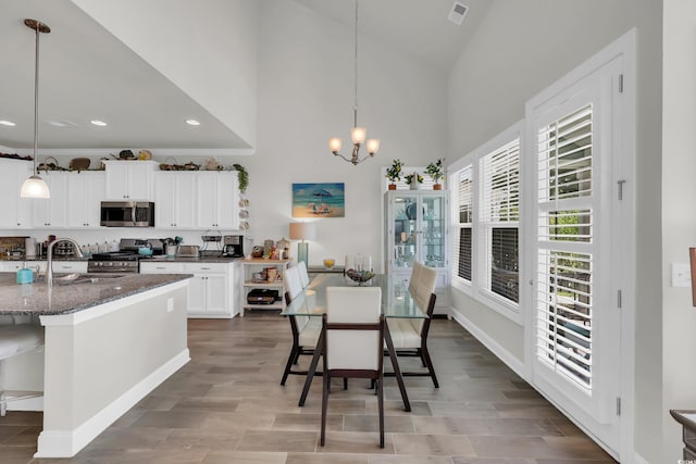 2766 Stellar Loop, Myrtle Beach, SC 29577 - dining space with a chandelier, recessed lighting, high vaulted ceiling, and light wood-type flooring