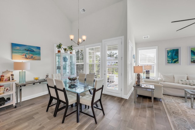 2766 Stellar Loop, Myrtle Beach, SC 29577 - dining room featuring wood finished floors, healthy amount of natural light, a chandelier, and high vaulted ceiling