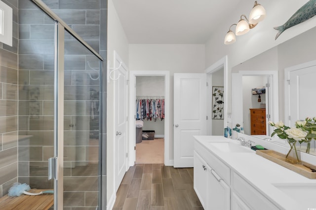 2766 Stellar Loop, Myrtle Beach, SC 29577 - bathroom with double vanity, a spacious closet, a stall shower, and wood tiled floors