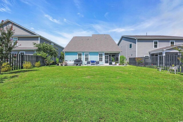 2766 Stellar Loop, Myrtle Beach, SC 29577 - rear view of house with a sunroom, a fenced backyard, and a patio area