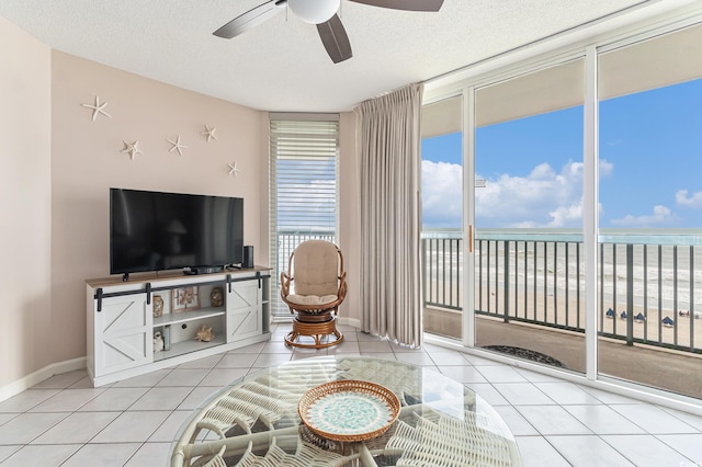 102 N Ocean Blvd Unit 508, North Myrtle Beach, SC 29582 - tiled living room featuring ceiling fan, a wall of windows, and a textured ceiling