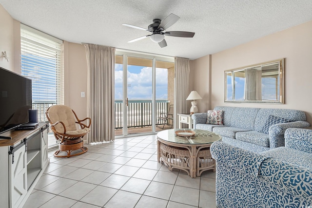 102 N Ocean Blvd Unit 508, North Myrtle Beach, SC 29582 - living room featuring a ceiling fan, a textured ceiling, light tile patterned flooring, and floor to ceiling windows