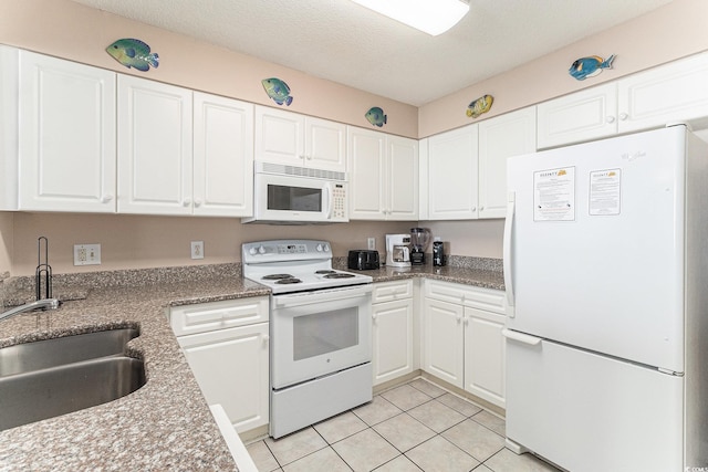 102 N Ocean Blvd Unit 508, North Myrtle Beach, SC 29582 - kitchen featuring white appliances, light tile patterned flooring, and white cabinetry