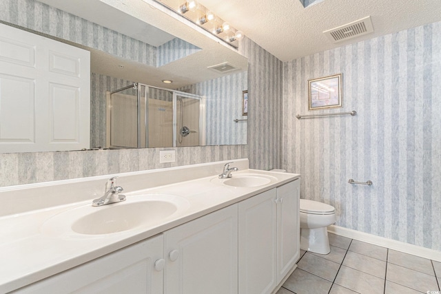 102 N Ocean Blvd Unit 508, North Myrtle Beach, SC 29582 - bathroom featuring wallpapered walls, tile patterned floors, a shower stall, double vanity, and a textured ceiling