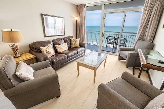 2000 N Ocean Blvd Unit 1117, Myrtle Beach, SC 29577 - living room featuring a wall of windows, a water view, and light wood-type flooring