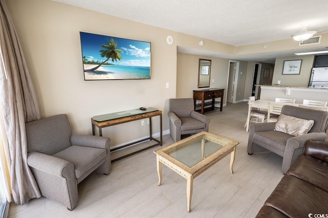 2000 N Ocean Blvd Unit 1117, Myrtle Beach, SC 29577 - living area with baseboards and a textured ceiling