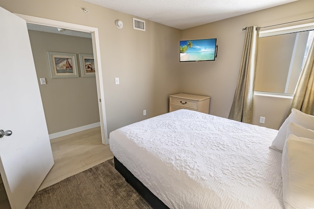 2000 N Ocean Blvd Unit 1117, Myrtle Beach, SC 29577 - tiled bedroom with a textured ceiling