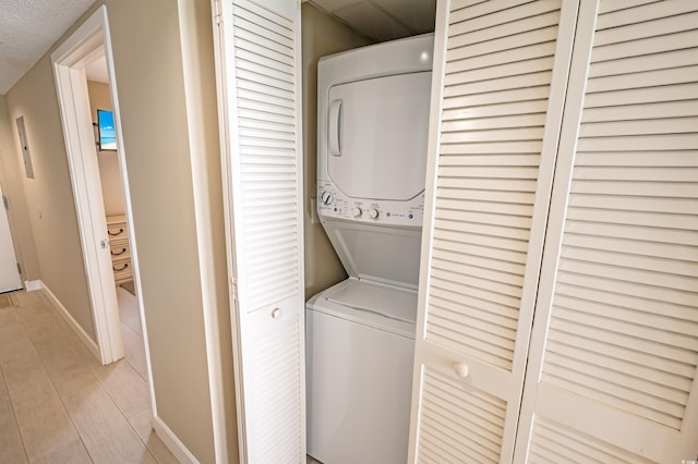 2000 N Ocean Blvd Unit 1117, Myrtle Beach, SC 29577 - washroom featuring stacked washer / dryer and baseboards
