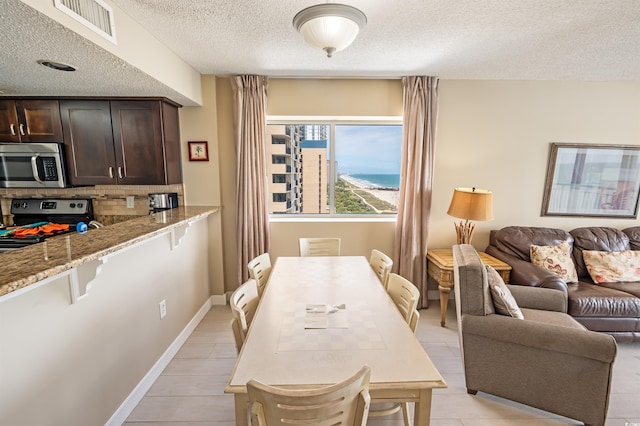 2000 N Ocean Blvd Unit 1117, Myrtle Beach, SC 29577 - dining space with a textured ceiling and baseboards