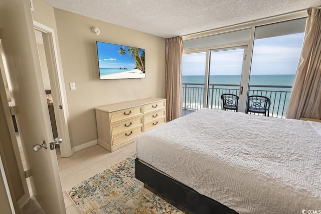 2000 N Ocean Blvd Unit 1117, Myrtle Beach, SC 29577 - bedroom featuring access to exterior, a textured ceiling, and light tile patterned floors