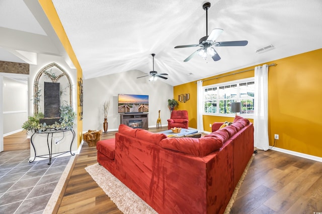 209 Chickasaw Ln, Myrtle Beach, SC 29579 - living area with ceiling fan, vaulted ceiling, wood finished floors, and a glass covered fireplace
