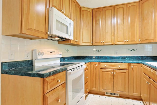3916 Quail Cir, Myrtle Beach, SC 29579 - kitchen with white appliances, dark countertops, and tasteful backsplash