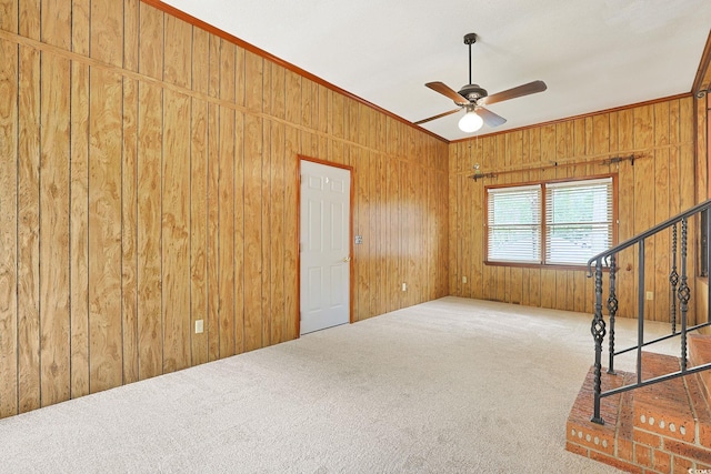 3916 Quail Cir, Myrtle Beach, SC 29579 - carpeted spare room featuring ceiling fan, wood walls, ornamental molding, and stairway