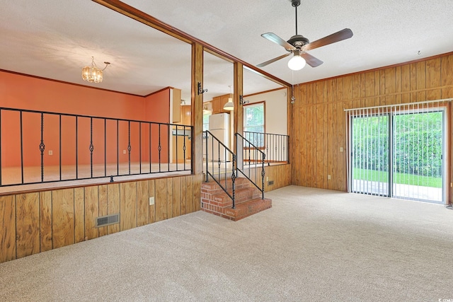 3916 Quail Cir, Myrtle Beach, SC 29579 - unfurnished room with wood walls, carpet, a chandelier, a ceiling fan, and a textured ceiling