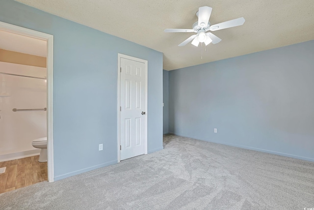 3916 Quail Cir, Myrtle Beach, SC 29579 - unfurnished bedroom featuring carpet floors, connected bathroom, a textured ceiling, and ceiling fan