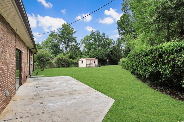 3916 Quail Cir, Myrtle Beach, SC 29579 - view of green lawn with a patio area and an outdoor structure
