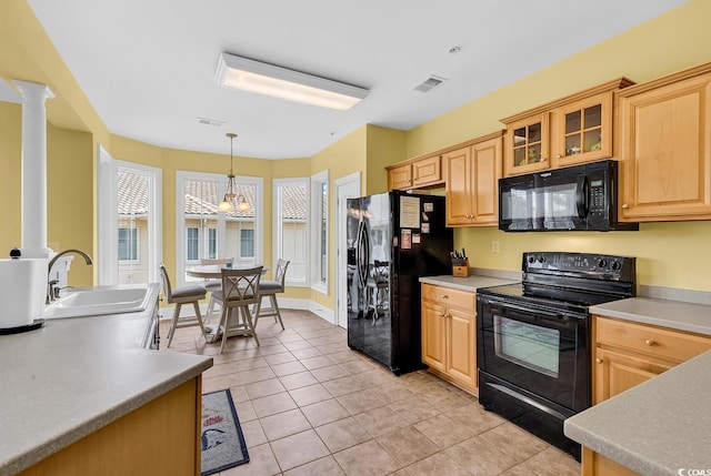 2180 Waterview Dr Unit 647, North Myrtle Beach, SC 29582 - kitchen featuring black appliances, ornate columns, light tile patterned floors, glass insert cabinets, and decorative light fixtures
