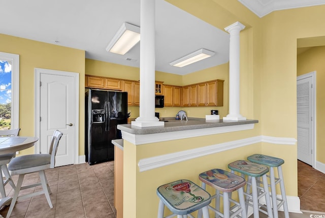 2180 Waterview Dr Unit 647, North Myrtle Beach, SC 29582 - kitchen with ornate columns, black appliances, light tile patterned floors, a kitchen breakfast bar, and a peninsula