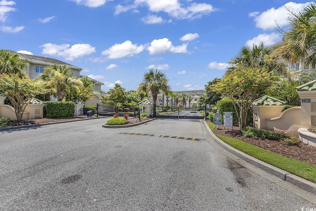 2180 Waterview Dr Unit 647, North Myrtle Beach, SC 29582 - view of asphalt street featuring a residential view, a gate, curbs, and a gated entry