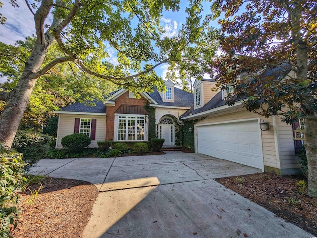 25 Deloach Trl, Pawleys Island, SC 29585 - traditional-style house featuring driveway, a garage, and a shingled roof