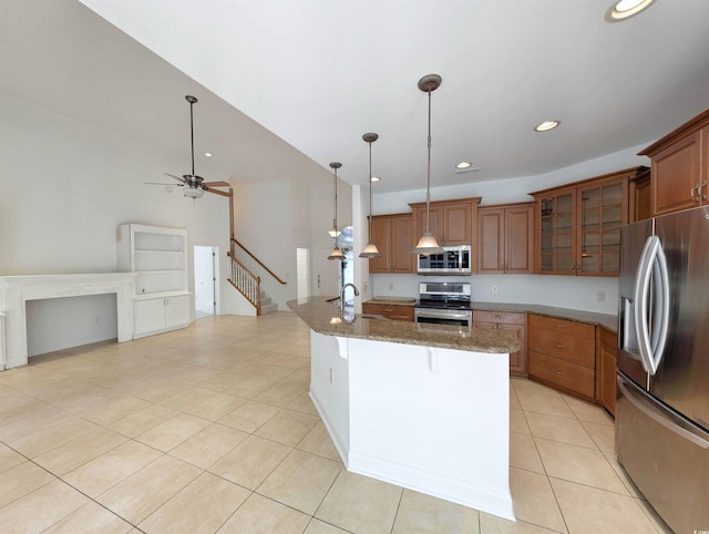 25 Deloach Trl, Pawleys Island, SC 29585 - kitchen with stainless steel appliances, brown cabinets, a breakfast bar, light tile patterned floors, and recessed lighting