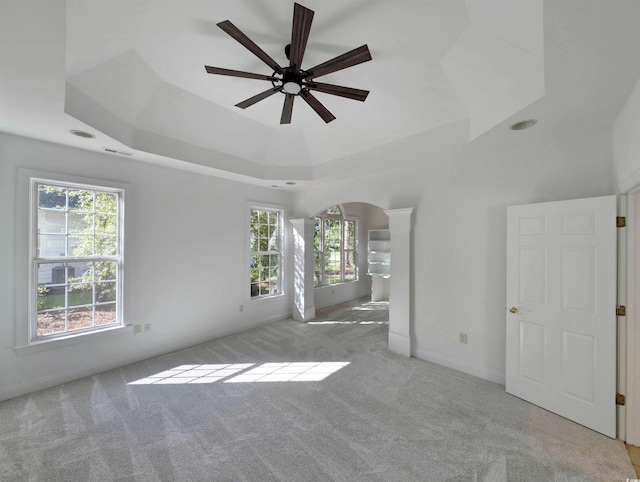 25 Deloach Trl, Pawleys Island, SC 29585 - unfurnished room featuring arched walkways, ceiling fan, carpet floors, and a raised ceiling