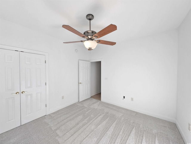 25 Deloach Trl, Pawleys Island, SC 29585 - unfurnished bedroom featuring light carpet, a closet, and a ceiling fan