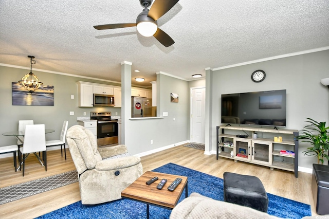 2187 Clearwater Dr Unit H, Surfside Beach, SC 29575 - living area featuring light wood finished floors, a ceiling fan, ornamental molding, and a textured ceiling