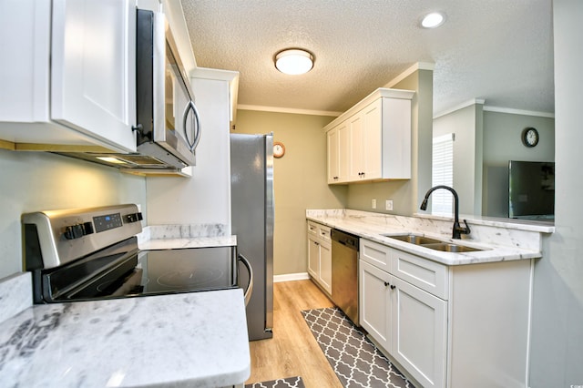 2187 Clearwater Dr Unit H, Surfside Beach, SC 29575 - kitchen featuring stainless steel appliances, ornamental molding, light wood-type flooring, white cabinets, and a textured ceiling