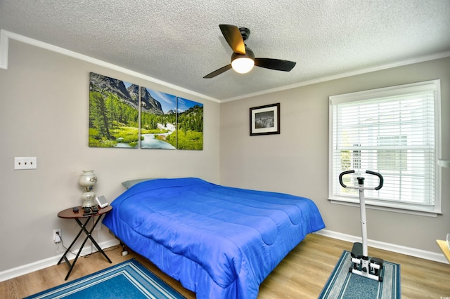 2187 Clearwater Dr Unit H, Surfside Beach, SC 29575 - bedroom featuring a textured ceiling, wood finished floors, ceiling fan, and ornamental molding