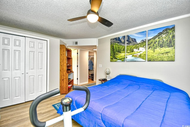 2187 Clearwater Dr Unit H, Surfside Beach, SC 29575 - bedroom featuring a textured ceiling, wood finished floors, a closet, and ceiling fan