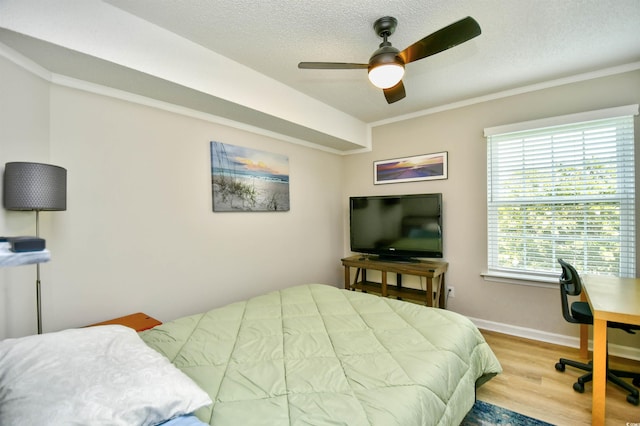 2187 Clearwater Dr Unit H, Surfside Beach, SC 29575 - bedroom featuring wood finished floors, a textured ceiling, a ceiling fan, and crown molding