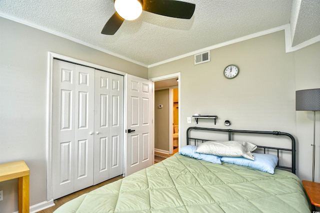 2187 Clearwater Dr Unit H, Surfside Beach, SC 29575 - bedroom featuring a textured ceiling, ornamental molding, a closet, wood finished floors, and ceiling fan