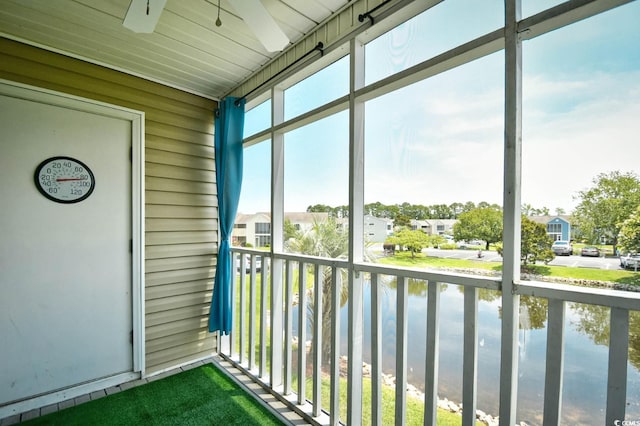 2187 Clearwater Dr Unit H, Surfside Beach, SC 29575 - unfurnished sunroom with a ceiling fan, a residential view, and a water view