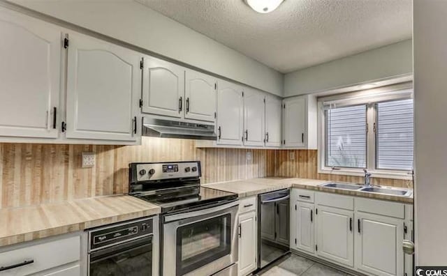 405 77th Ave N Unit 5, Myrtle Beach, SC 29572 - kitchen with stainless steel range with electric stovetop, dishwashing machine, under cabinet range hood, a textured ceiling, and light countertops