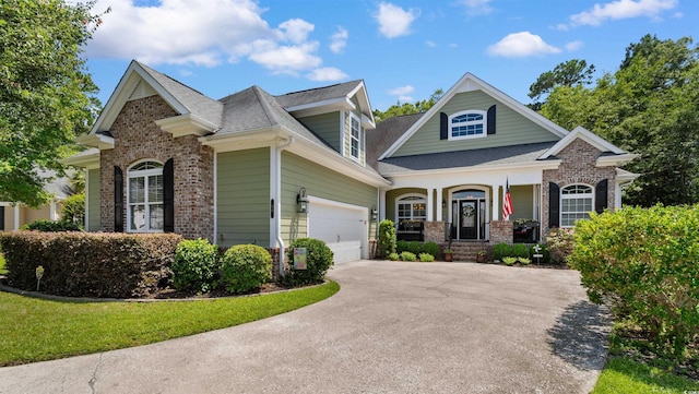 60 Springtime Ct, Murrells Inlet, SC 29576 - craftsman-style home featuring brick siding, a porch, asphalt driveway, and a garage