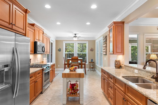60 Springtime Ct, Murrells Inlet, SC 29576 - kitchen featuring stainless steel appliances, decorative backsplash, crown molding, brown cabinets, and a ceiling fan