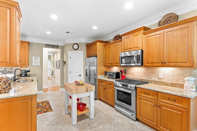 60 Springtime Ct, Murrells Inlet, SC 29576 - kitchen with stainless steel appliances, tasteful backsplash, light tile patterned floors, light stone counters, and crown molding