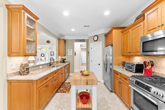 60 Springtime Ct, Murrells Inlet, SC 29576 - kitchen with appliances with stainless steel finishes, ornamental molding, backsplash, glass insert cabinets, and light stone counters