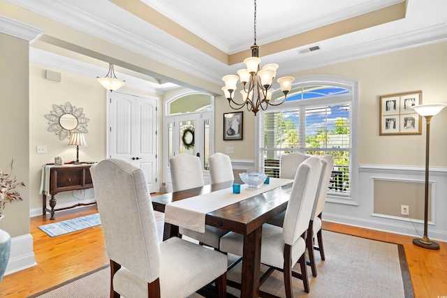 60 Springtime Ct, Murrells Inlet, SC 29576 - dining area featuring a chandelier, a raised ceiling, ornamental molding, and light wood-type flooring