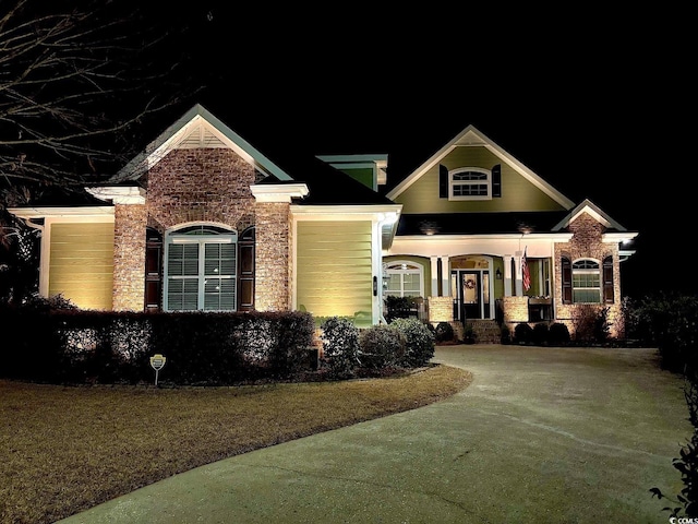 60 Springtime Ct, Murrells Inlet, SC 29576 - craftsman-style home with driveway, a garage, a yard, and brick siding