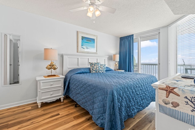 5310 N Ocean Blvd Unit 7C, North Myrtle Beach, SC 29582 - bedroom featuring access to exterior, a textured ceiling, light wood-style floors, and ceiling fan