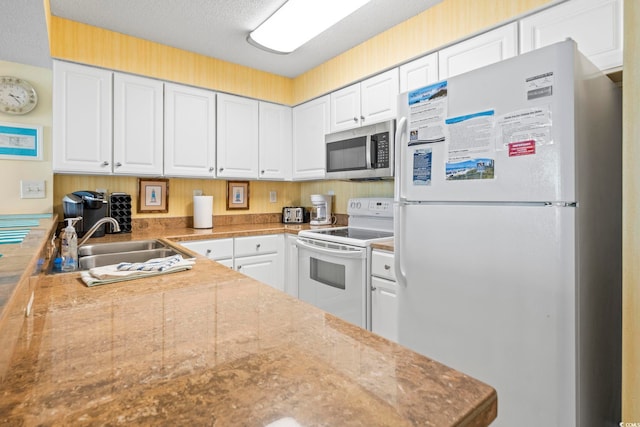 5310 N Ocean Blvd Unit 7C, North Myrtle Beach, SC 29582 - kitchen featuring white appliances, white cabinets, and a textured ceiling