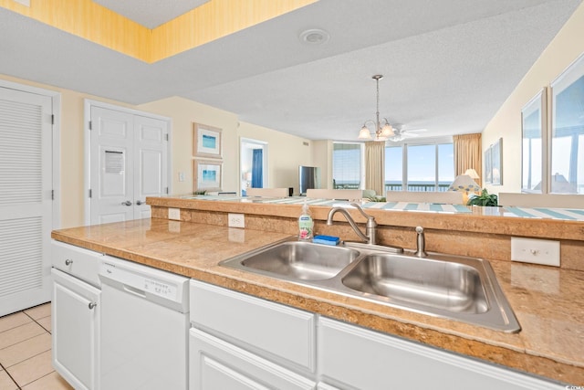 5310 N Ocean Blvd Unit 7C, North Myrtle Beach, SC 29582 - kitchen featuring white dishwasher, white cabinetry, light countertops, and light tile patterned floors
